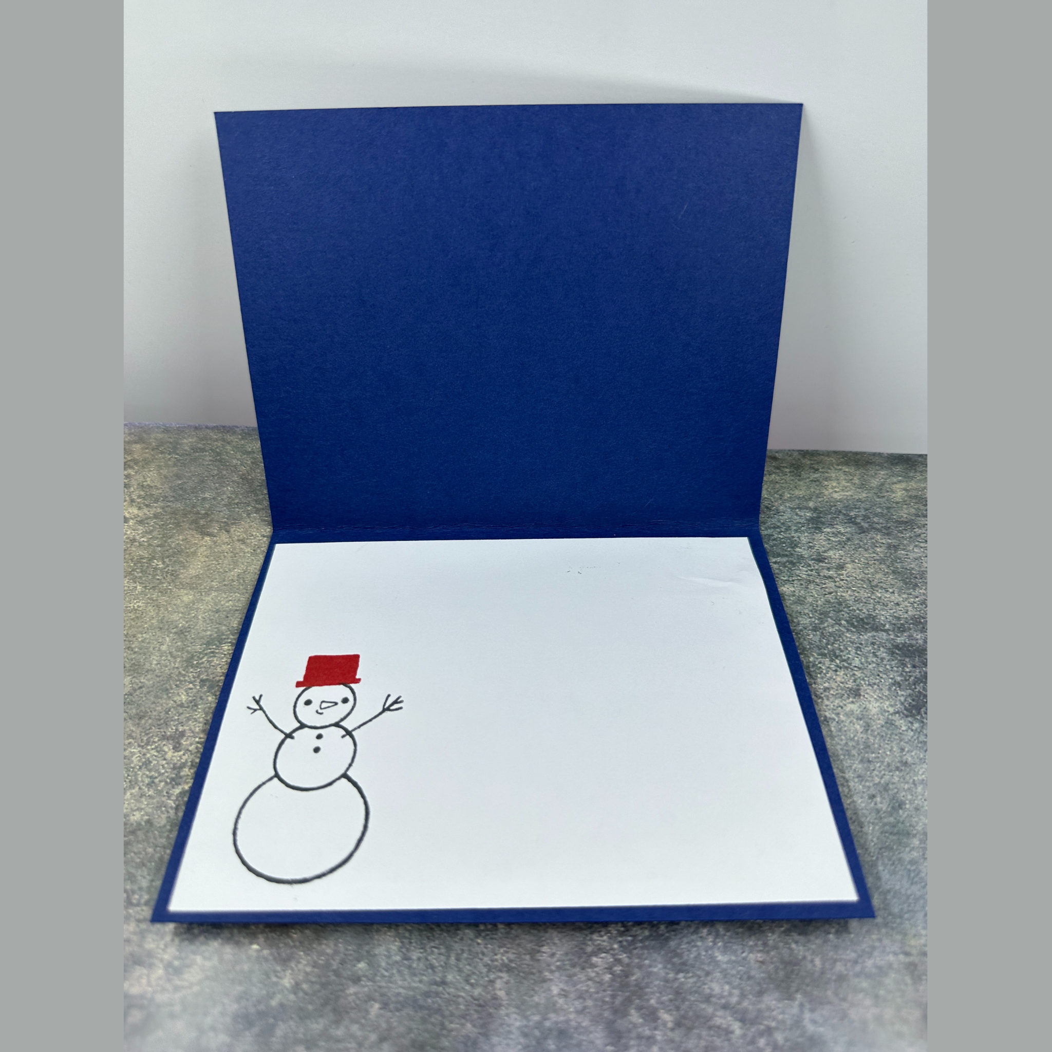 Sparkling Snowman Holiday Card with Cozy Home and Snowflake Accents